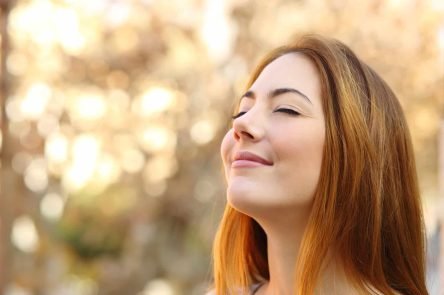 Beautiful Woman Doing Breath Exercises With An Autumn Background